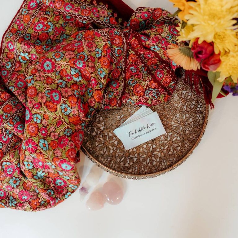 Brand visuals Top view of colourful flowers, throw, business cards and rose quartz